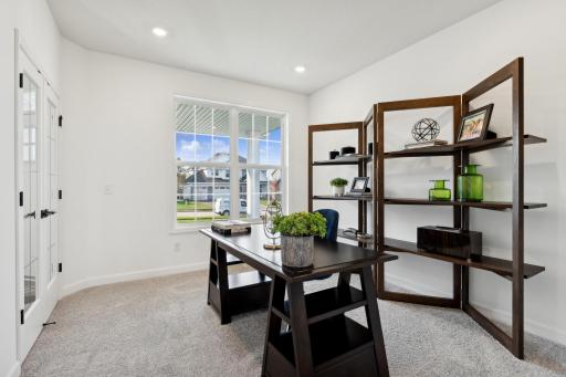 (Photo of a decorated model, actual homes finishes will vary) There is a dedicated flex room space that extends off of the foyer which can be used for a home office, formal dining space or another family room for the main level.