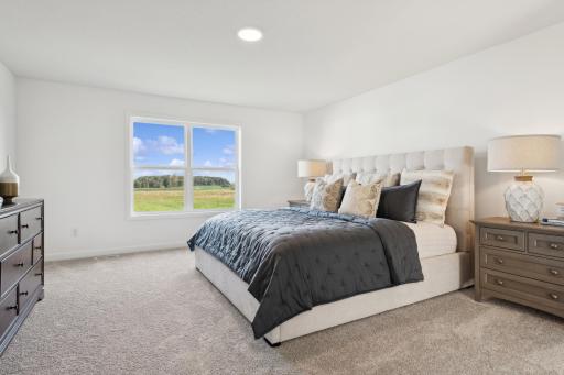(Photo of a decorated model, actual homes finishes will vary) Be impressed with the large primary bedroom that offers its own private ensuite bath and walk-in closet.
