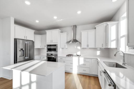 (Photo of a decorated model, actual homes finishes will vary) Another view of the kitchen.