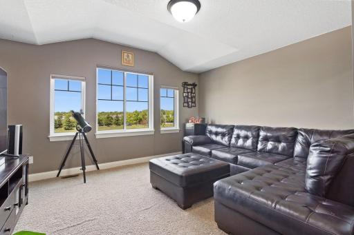 Loft has views of open green space and lake to the front
