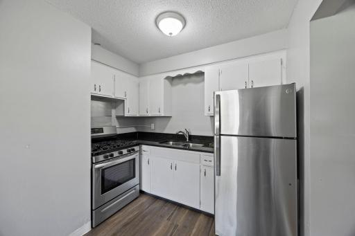 Unit 1 - Kitchen featuring stainless steel appliances, including a gas stove.
