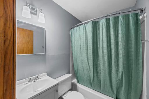 Unit 3 - Full bathroom with a clean, functional layout.
