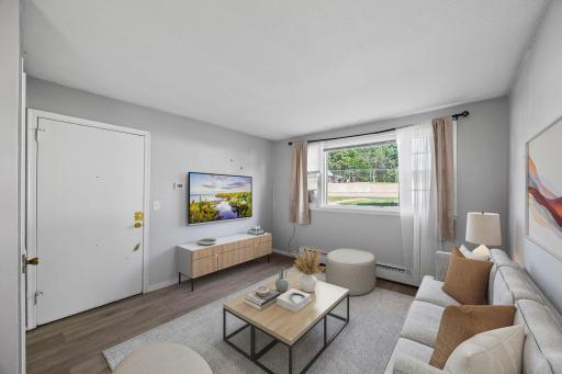 Unit 2 - Spacious living room flooded with natural light.