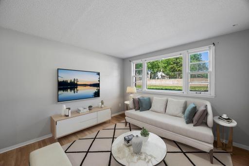 Unit 1 - Spacious living room flooded with natural light.