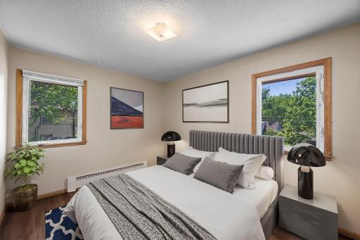 Unit 4 - Primary bedroom with views of both the side and backyard.