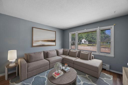 Unit 3 - Living room filled with natural light from large surrounding windows.