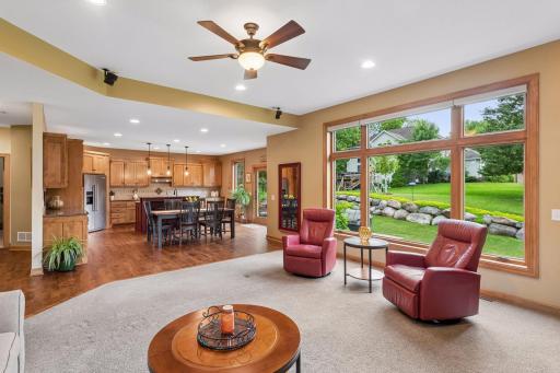 The spacious great room opens to the kitchen and dining area, with oversized windows that bring the outdoors in and create a bright, airy feel