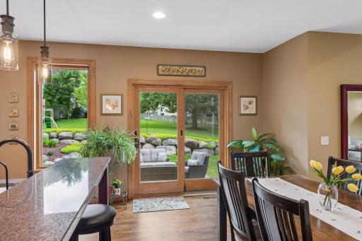 Large patio door and oversized window highlight the beautiful backyard views. Step out to the peaceful backyard patio for seamless indoor-outdoor living.