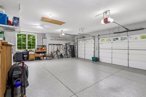 Oversized heated 3 car garage with epoxy floors and abundant storage