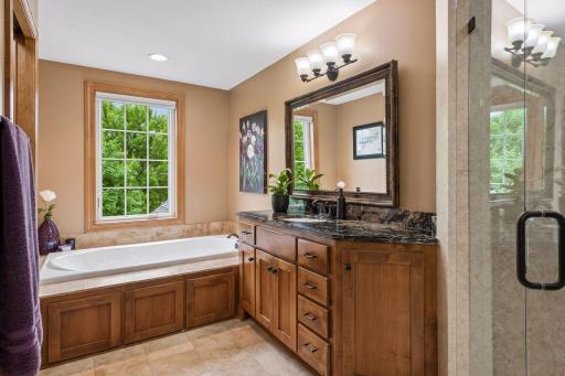Primary bathroom with separate soaking tub and separate dual vanities