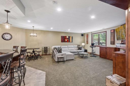 Designed for gathering, this spacious lower level offers comfortable seating areas, room for games and conversation, and a custom pub-style bar that naturally become a favorite spot when guests arrive.