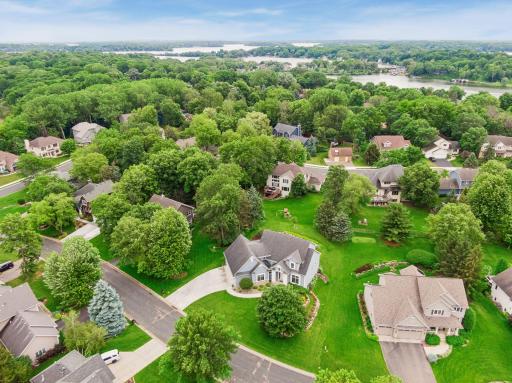From above, the homes exceptional setting comes into focus - nestled among mature trees on a picturesque lot in Saunders Lake, just minutes from Lake Minnetonka and the Dakota Rail Regional Trail