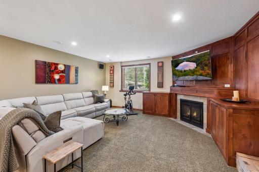 Rich woodwork, custom built-ins, and a cozy fireplace, create a family room that feels warm and cozy