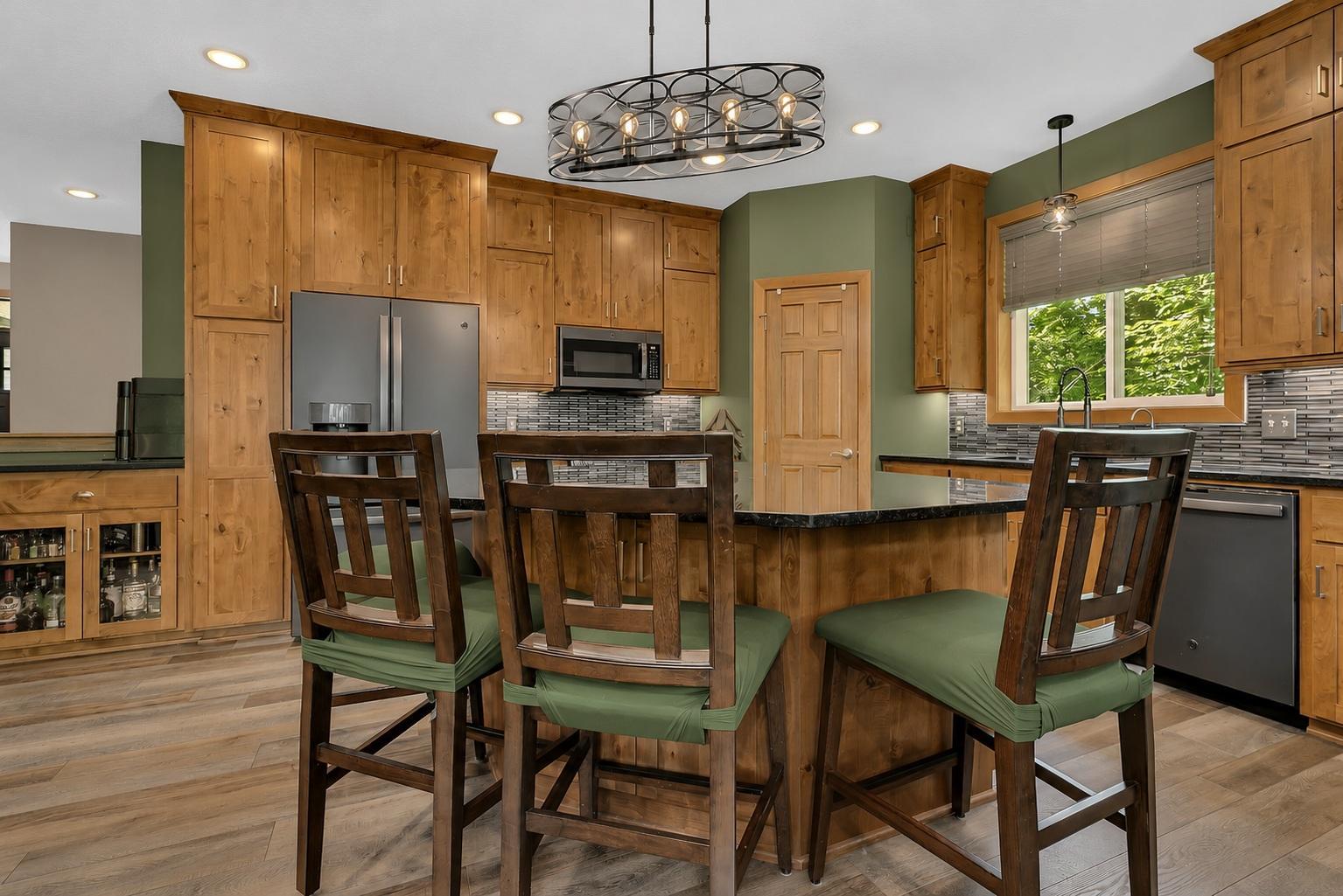 Step inside to an inviting open-concept floor plan showcasing custom alder cabinetry, granite countertops, ample storage, and stylish finishes throughout.