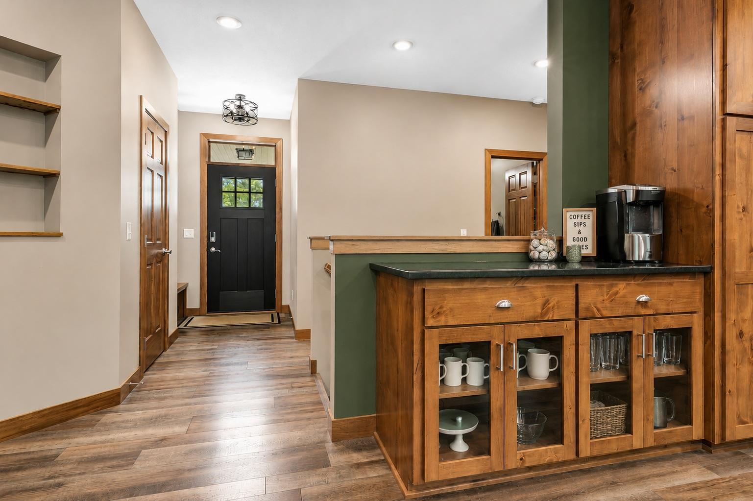 The custom built-in beverage center creates the perfect spot for your morning coffee or evening refreshments, complete with extra cabinetry, display storage, and convenient counter space.