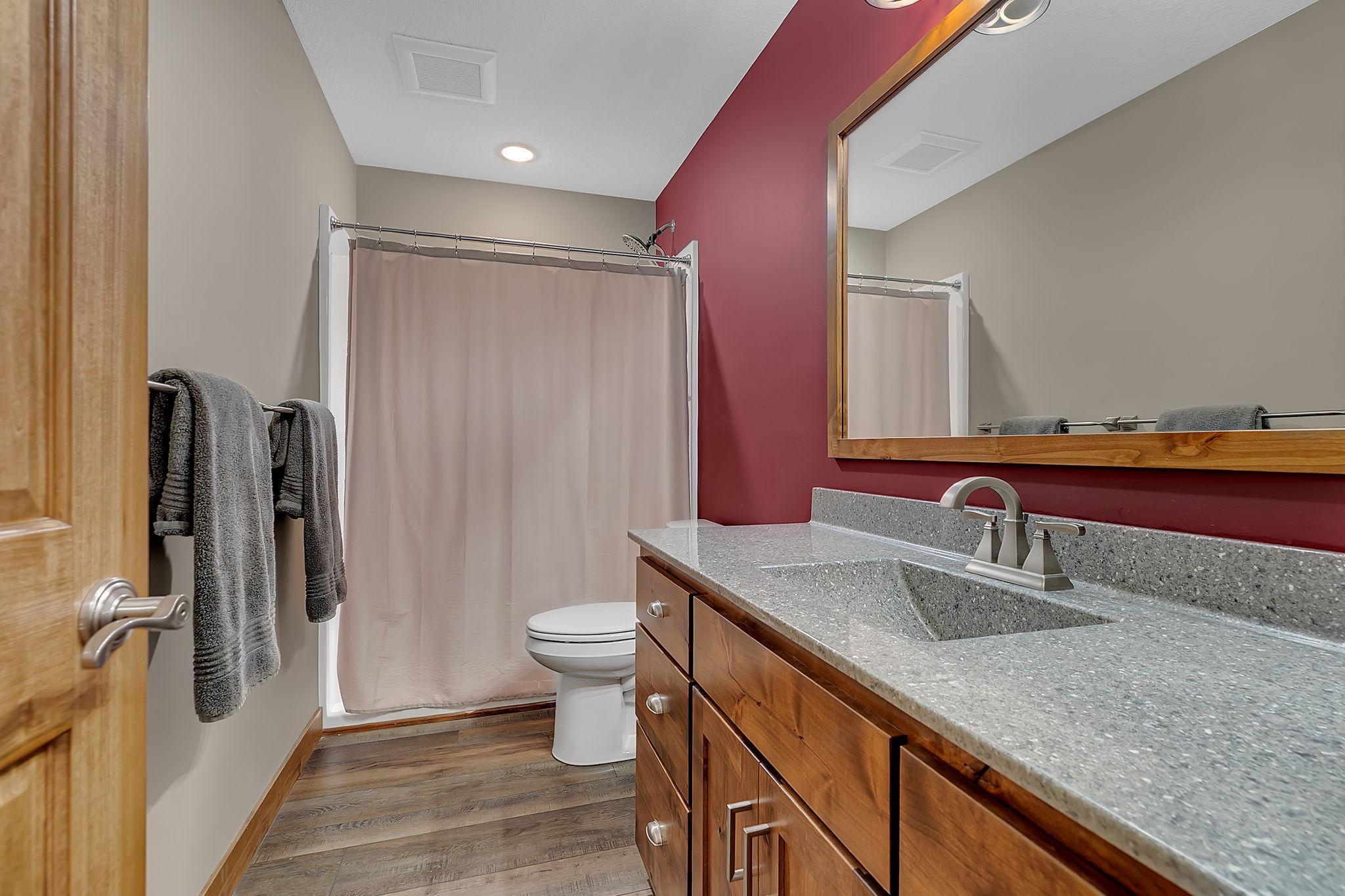 Designed to serve the lower level, this 3/4 bathroom includes a large shower, oversized vanity, and abundant storage.