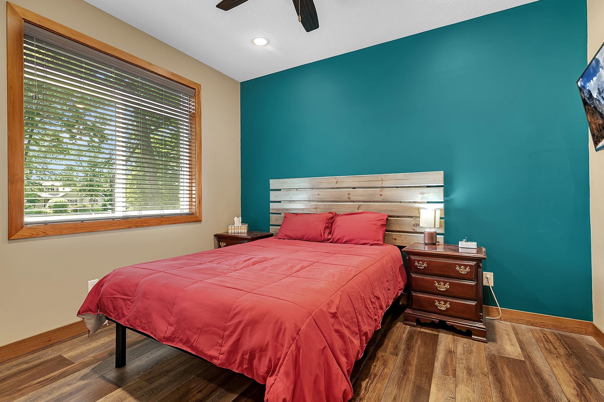 This main level bedroom provides easy access to the nearby full guest bathroom, creating a comfortable and functional space for family or visitors.