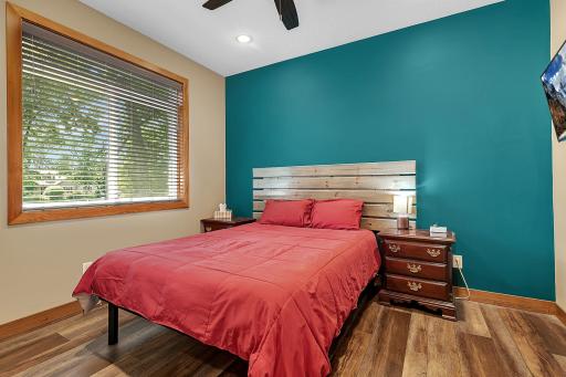 This main level bedroom provides easy access to the nearby full guest bathroom, creating a comfortable and functional space for family or visitors.
