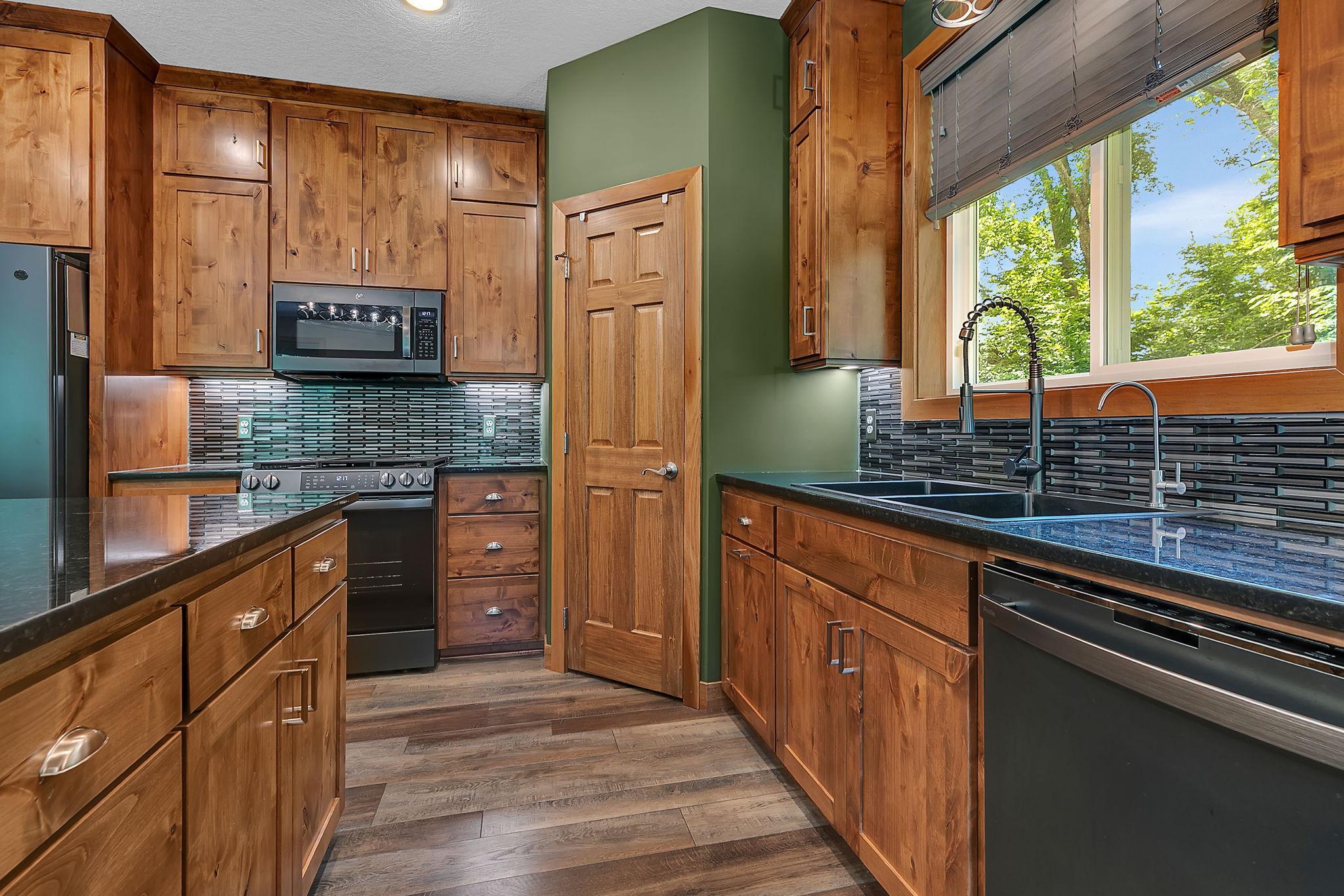 The eye catching tile backsplash adds a contemporary touch, while the large pantry and plentiful storage keep everything organized.
