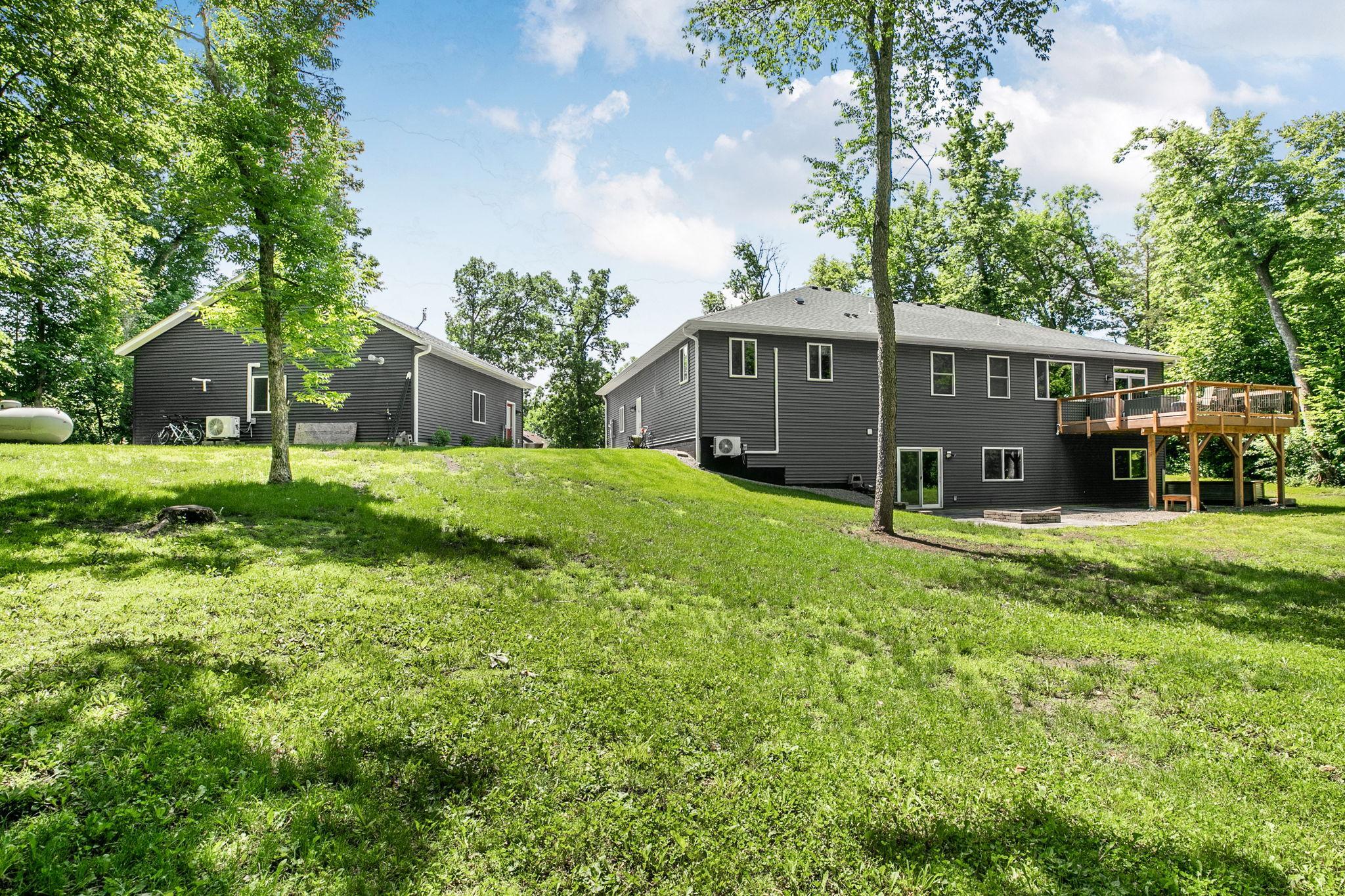From this vantage point, appreciate the thoughtfully designed walkout rambler, expansive composite deck, detached garage, and beautifully maintained grounds that create an exceptional place to call home.