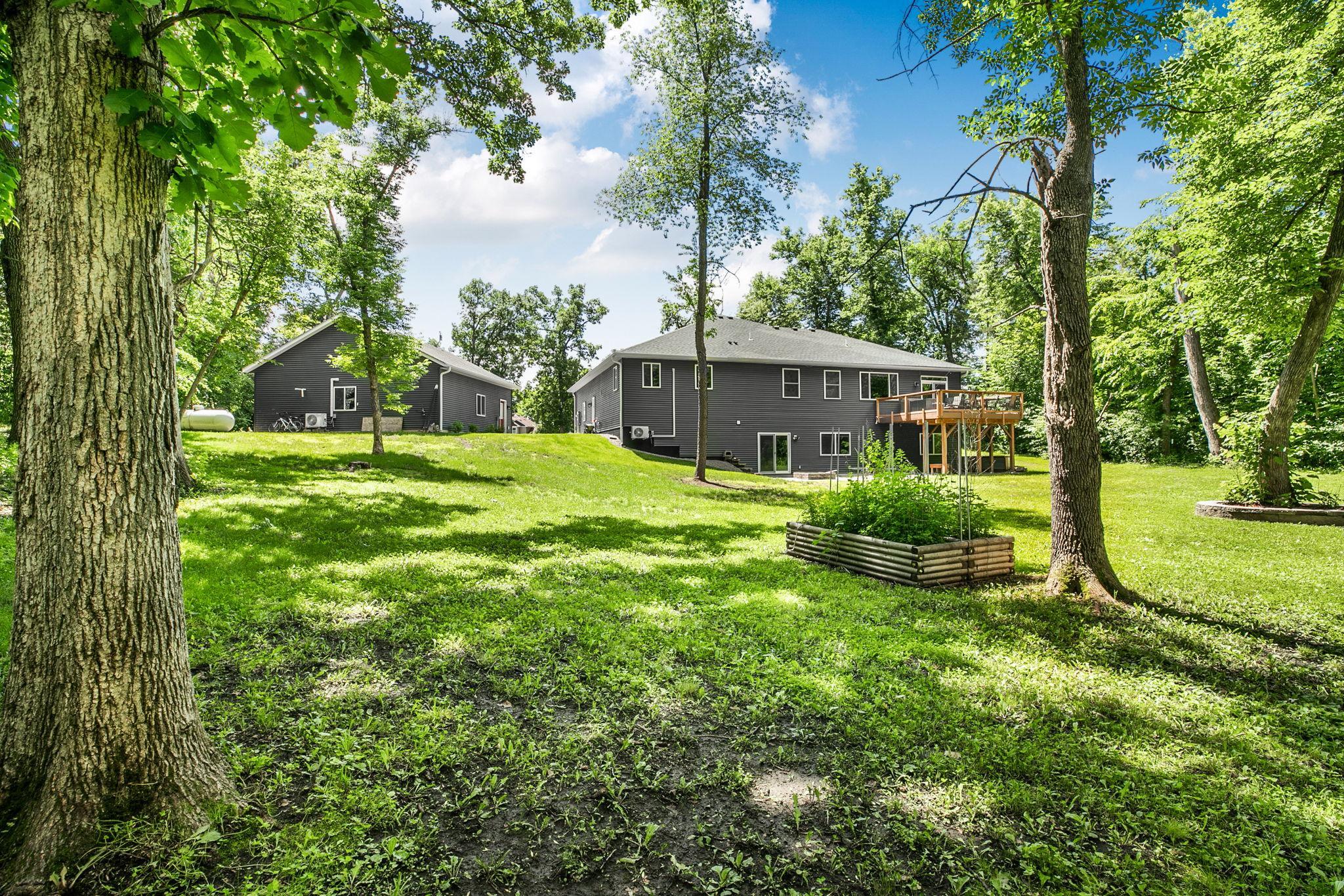 The generous backyard offers endless possibilities for outdoor recreation, gardening, entertaining, pets, or simply enjoying the serenity of your own wooded retreat.