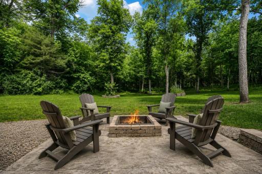 Gather around the inviting fire pit patio and enjoy peaceful evenings surrounded by mature trees and the privacy of 1.57 wooded acres. Perfect for entertaining, roasting marshmallows, or simply unwinding under the stars.