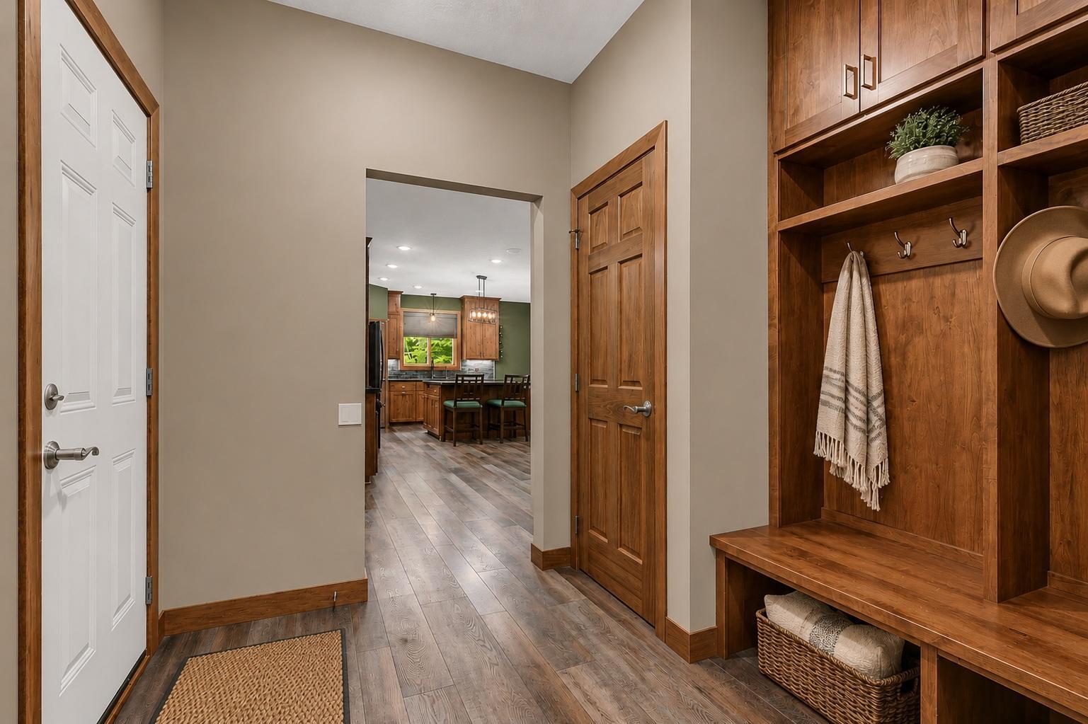 The large mudroom makes daily routines effortless with a built-in bench, coat hooks, open shelving, and additional cabinetry. Perfect for keeping shoes, jackets, bags, and seasonal gear neatly stored.