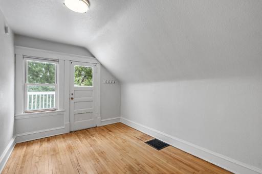 smaller bedroom with entry to balcony