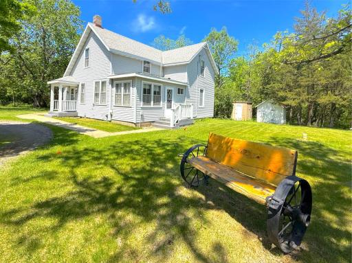 Classic farmhouse charm meets peaceful country living in this picturesque two-story home nestled among mature trees.