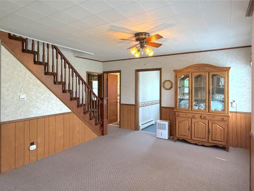The staircase adds character to the room, creating a warm and welcoming atmosphere at the heart of the home.
