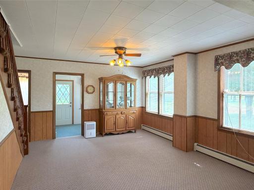 Filled with natural light from multiple large windows, this spacious dining room offers a warm and inviting space.
