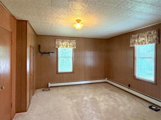 Comfortably sized with natural light, the main floor primary bedroom offers a peaceful retreat at the end of the day.