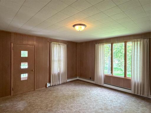 A wonderful space to welcome guests or enjoy a quiet afternoon, this formal living room is filled with natural light.