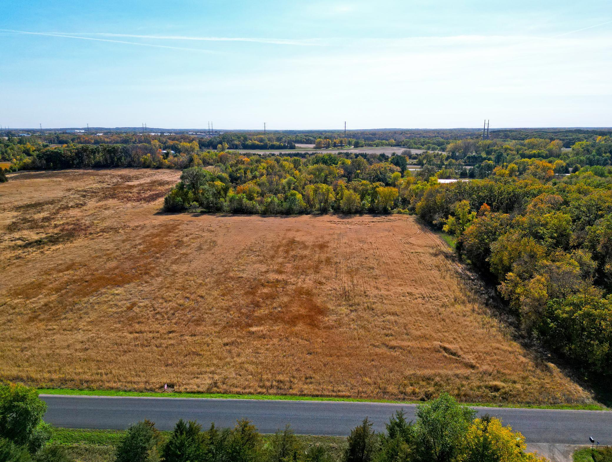 Beautiful 11.23-acre setting on Plum Creek featuring a blend of lightly wooded landscape and open farmland.
