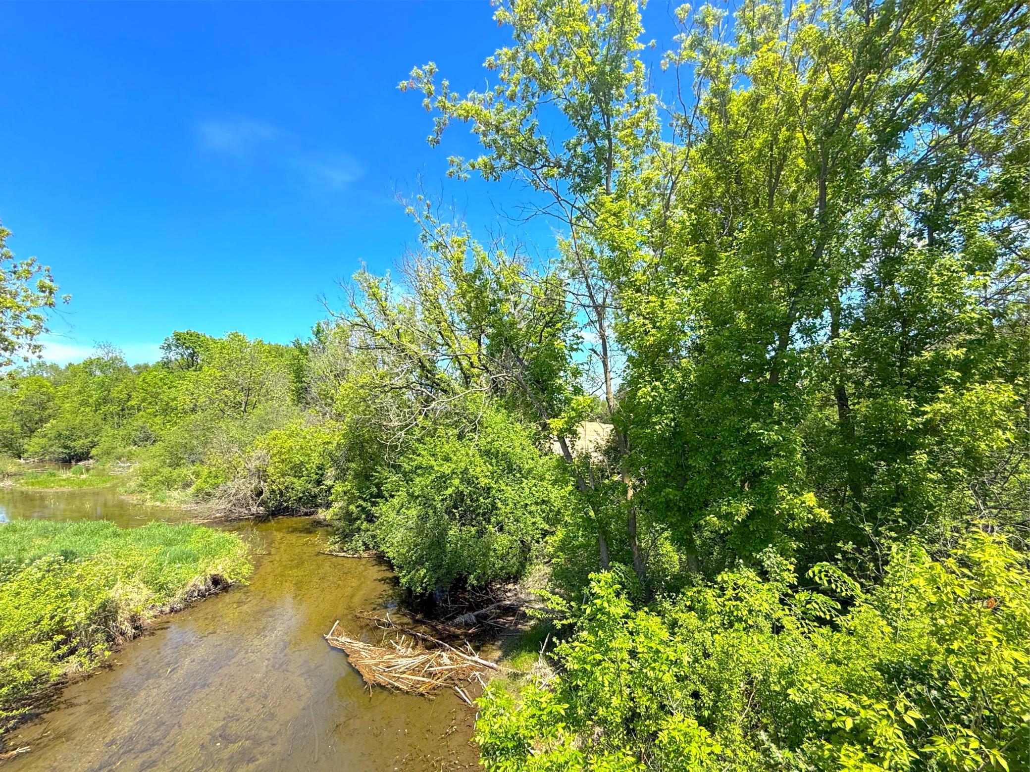 Gorgeous wooded 10-acre parcel on Plum Creek featuring shoreline on a small unnamed lake and seclusion.