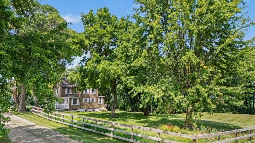 Pull up the gravel drive and this is the first thing you see: farmhouse, garage, and acres of green