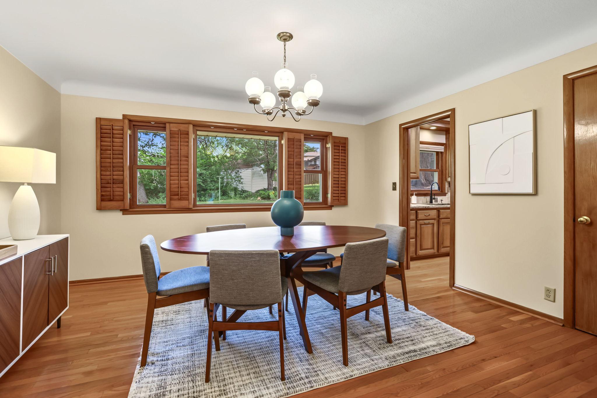 Living room flows through to dining room and kitchen. Windows overlooking backyard were all new in 2021.