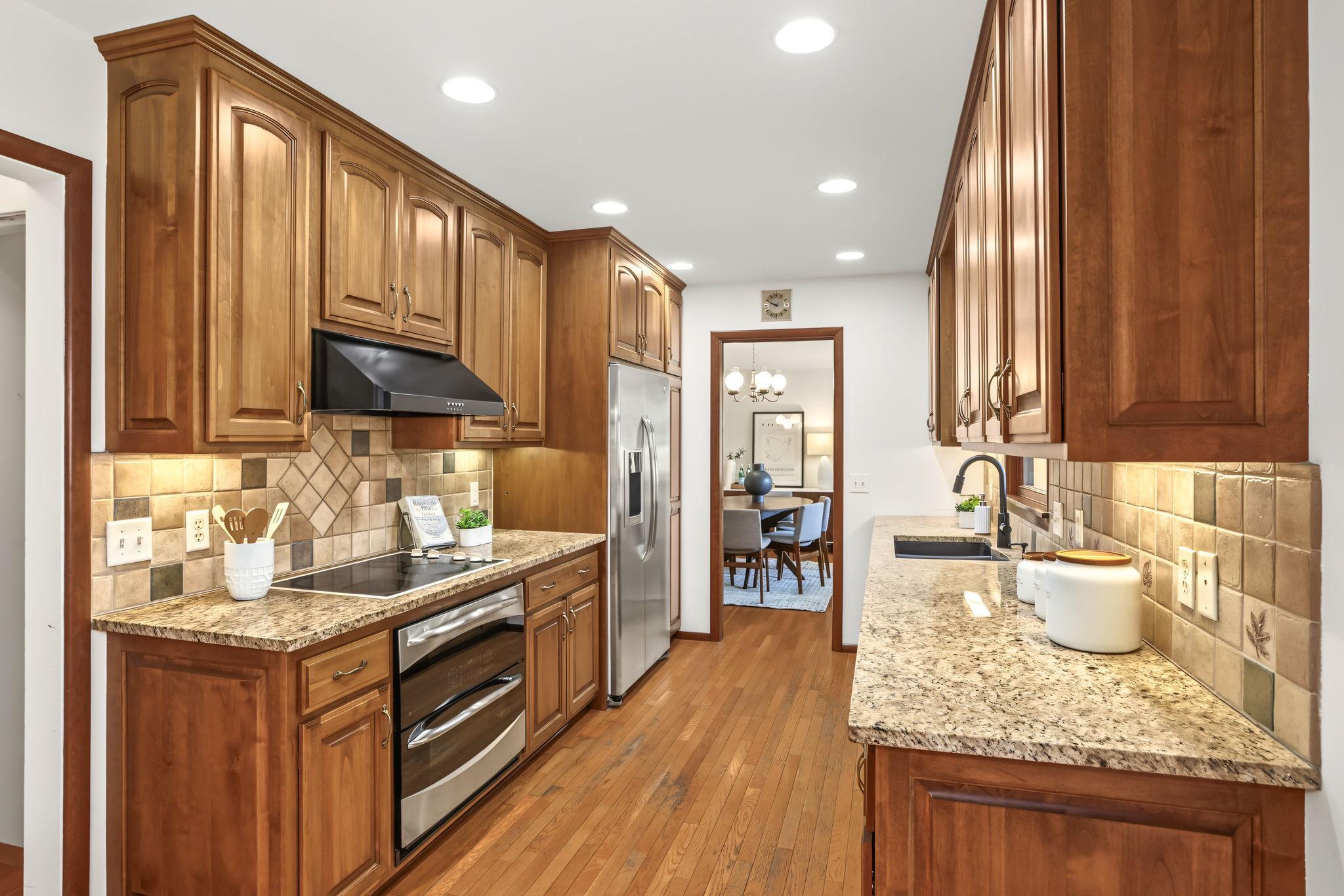 Updated kitchen with granite countertops and stainless steel appliances.
