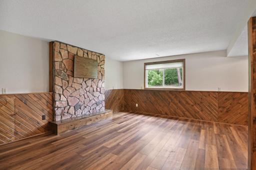 Check out this lower level family room! Bonus ~ there's a wet bar complete with beverage fridge