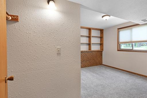 This lower level bedroom offers built-ins for added storage and display space