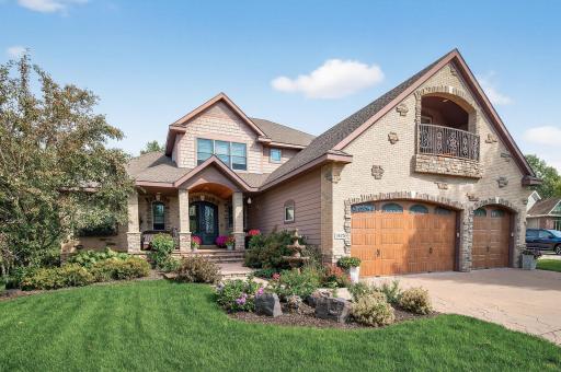 custom garage doors and balcony of the bonus room/office/5th bedroom