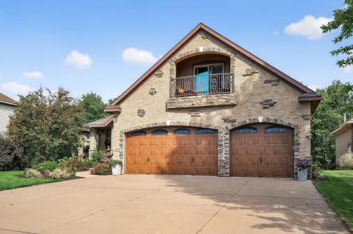 Colored concrete driveway and custom garage doors.