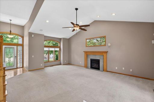 living room has vaulted ceilings and a gas fireplace