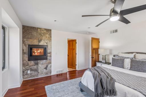 Cozy two sided fireplace in spacious primary suite.