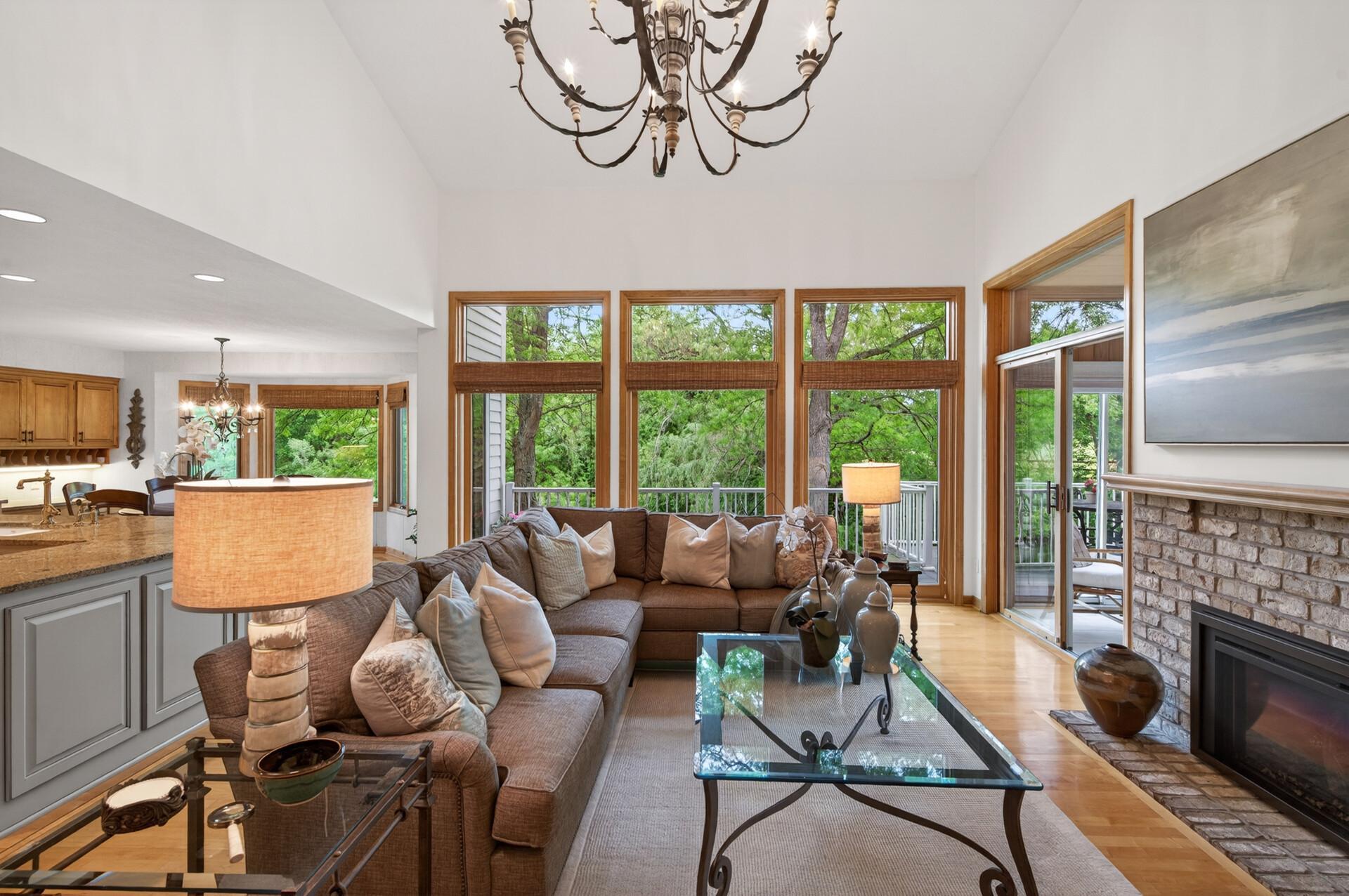 The main level living room is highlighted by a soaring 16-foot vaulted tray ceiling, while the impressive two-story family room is flooded with natural light from expansive windows overlooking the backyard