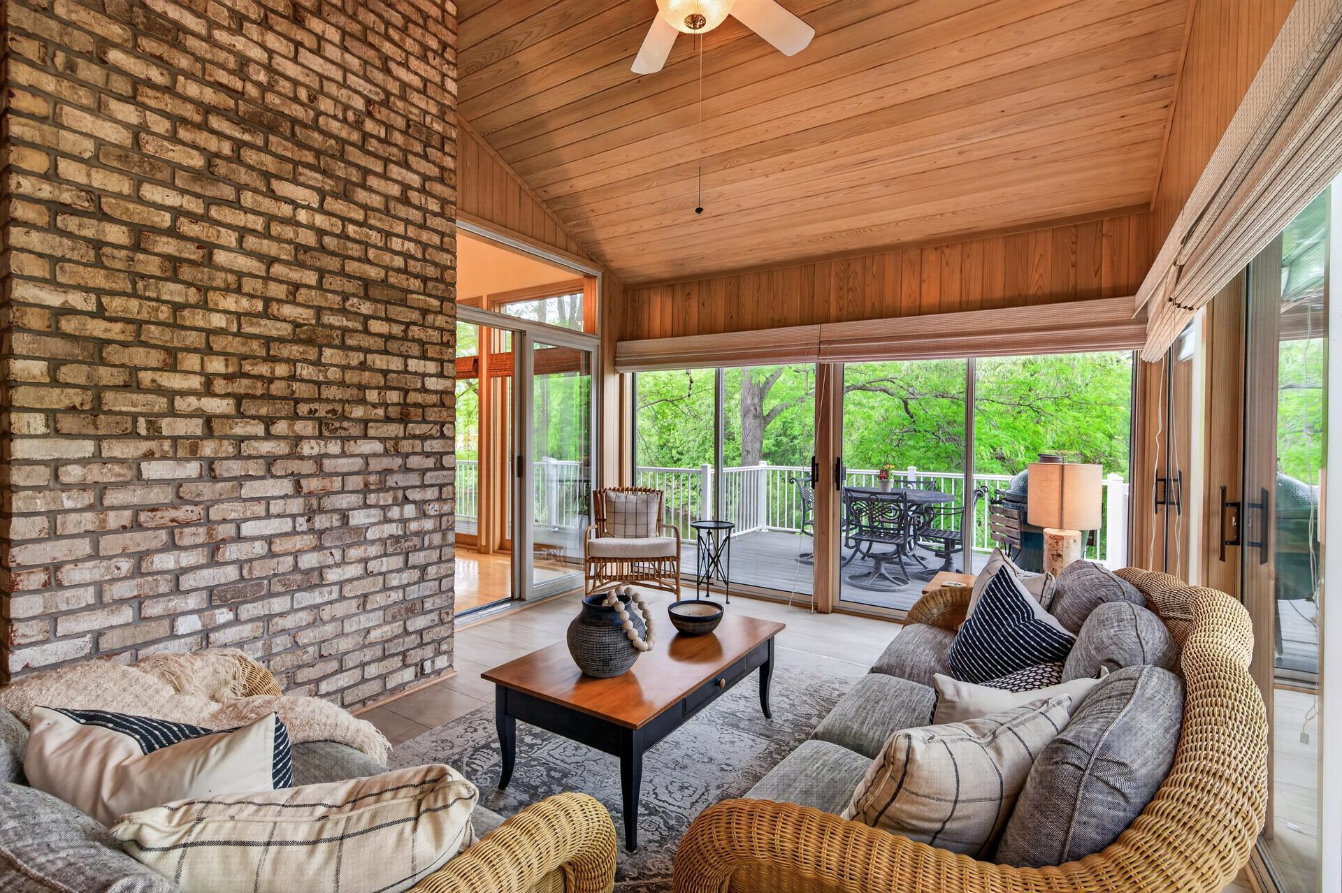 3-season porch with vaulted tongue-and-groove ceiling & walls, exposed brick chimney, and the perfect setting for quiet mornings or relaxed evenings.