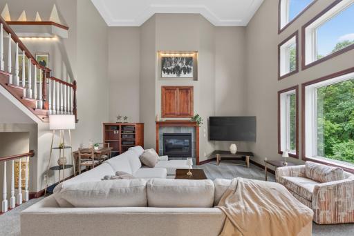 Anchored by a beautiful fireplace, this grand living room offers warmth, character, and timeless appeal.