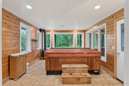 A private hot tub retreat offers the perfect place to relax and enjoy the peaceful waterfront setting.