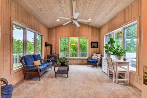Bathed in natural light and surrounded by views, this inviting sunroom offers the perfect place to relax in every season.