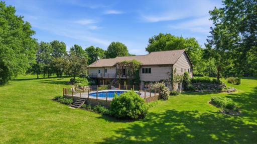 Stunning home situated on beautifully maintained grounds. Boulder retaining walls, climbing ivy, perennial flowering bushes and plants. 27' round pool, 2026 New Liner, Custom Railing and Sun Deck Surround.